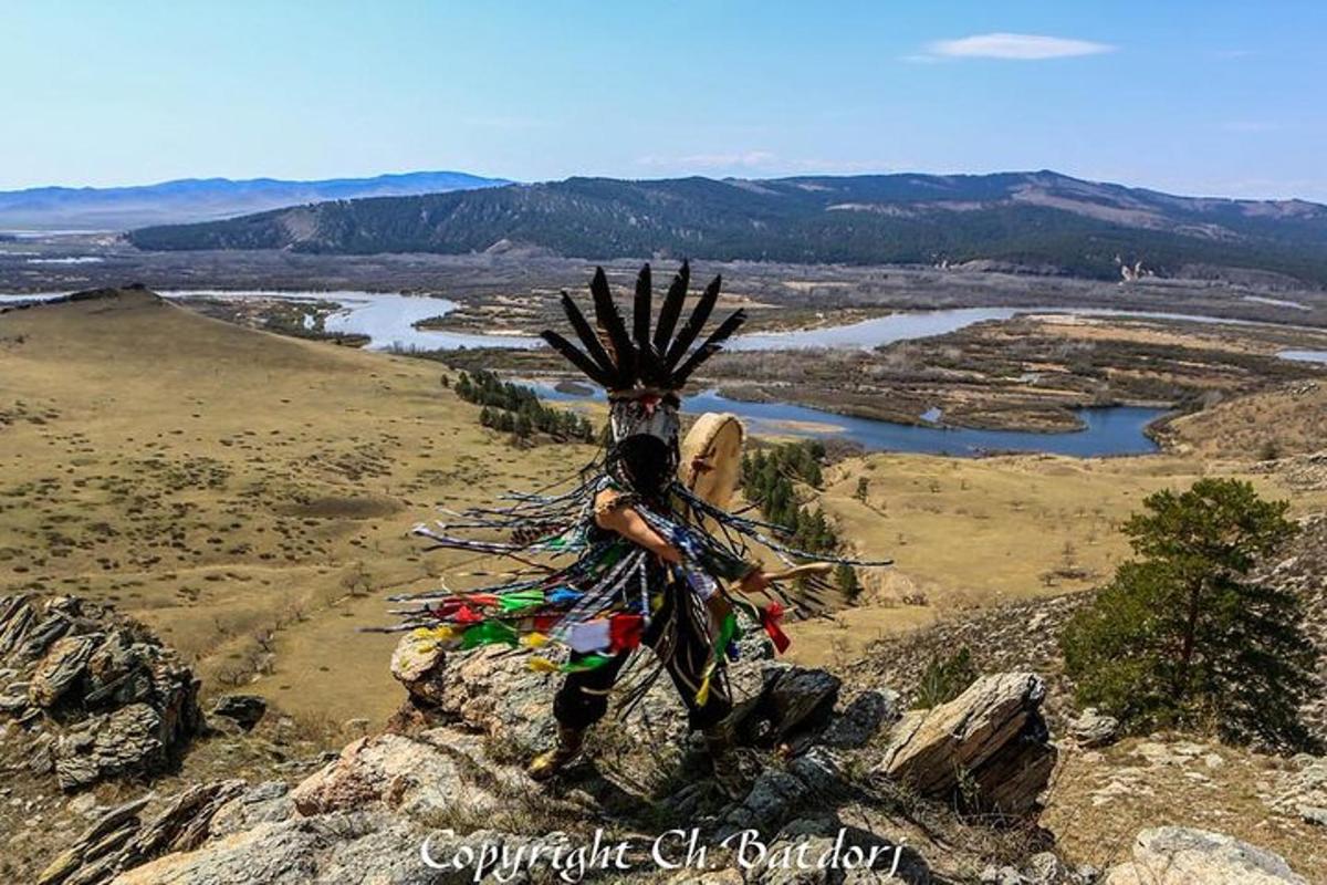 a statue of a person on top of a mountain