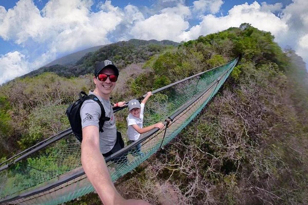 a man and a child on a suspension bridge