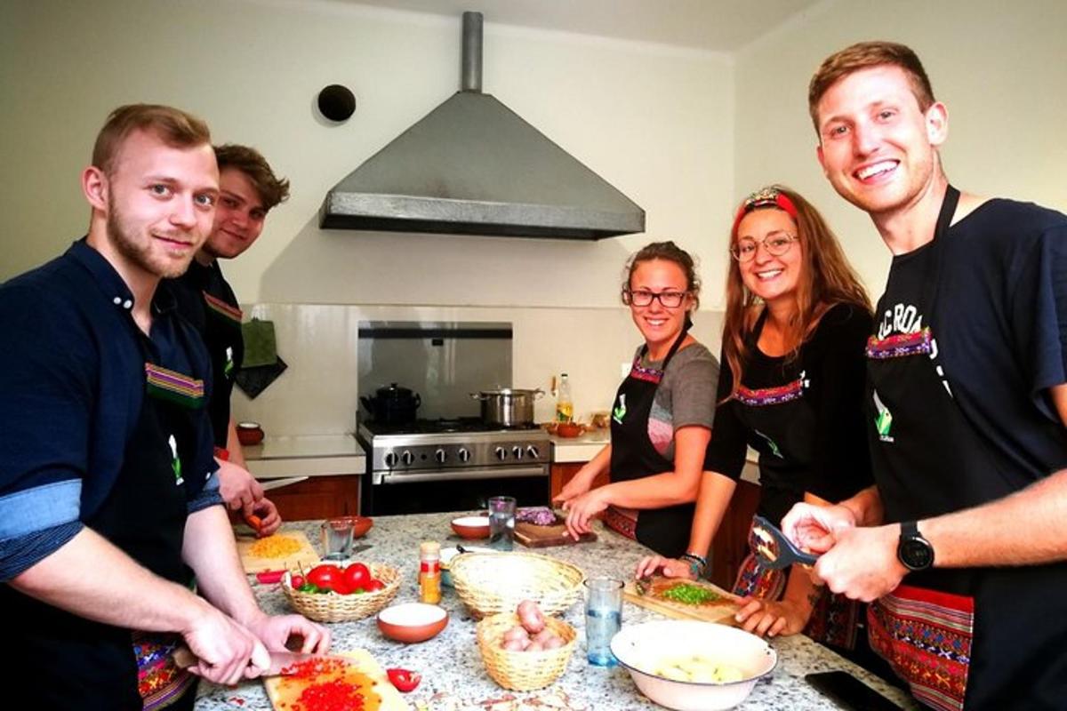 a group of people standing in a kitchen preparing food