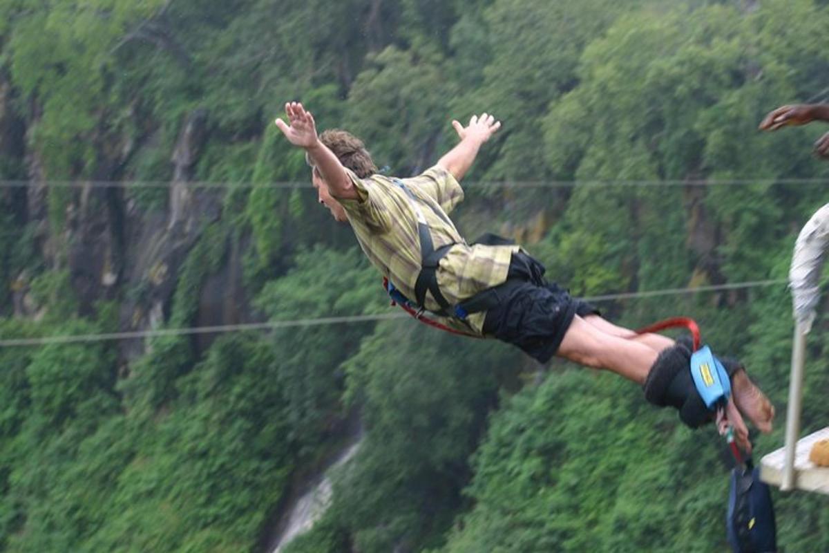 a man jumping in the air with his arms in the air