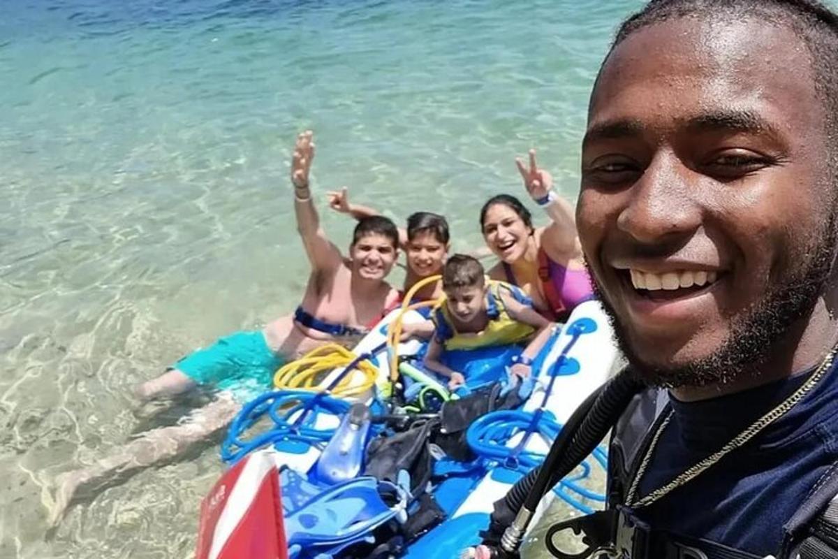 a man standing next to a group of people in the water