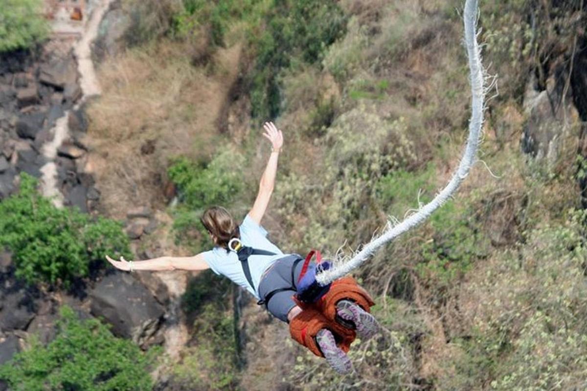 a woman on a zip line on a mountain