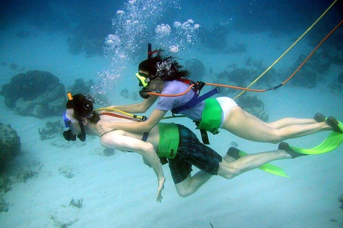 two people in the water playing with a rope