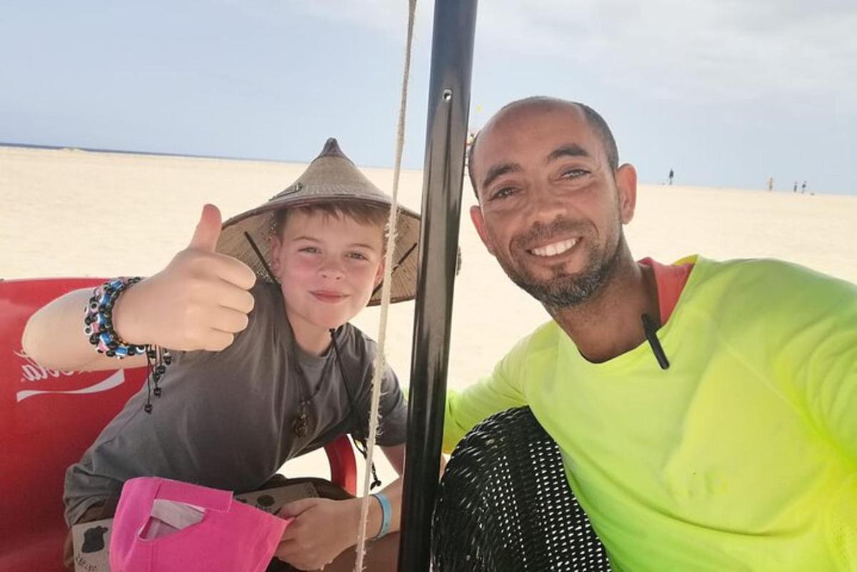 a man and a woman giving a thumbs up at the beach