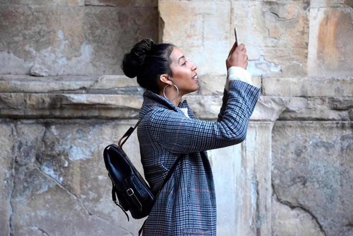 a woman taking a picture of a wall