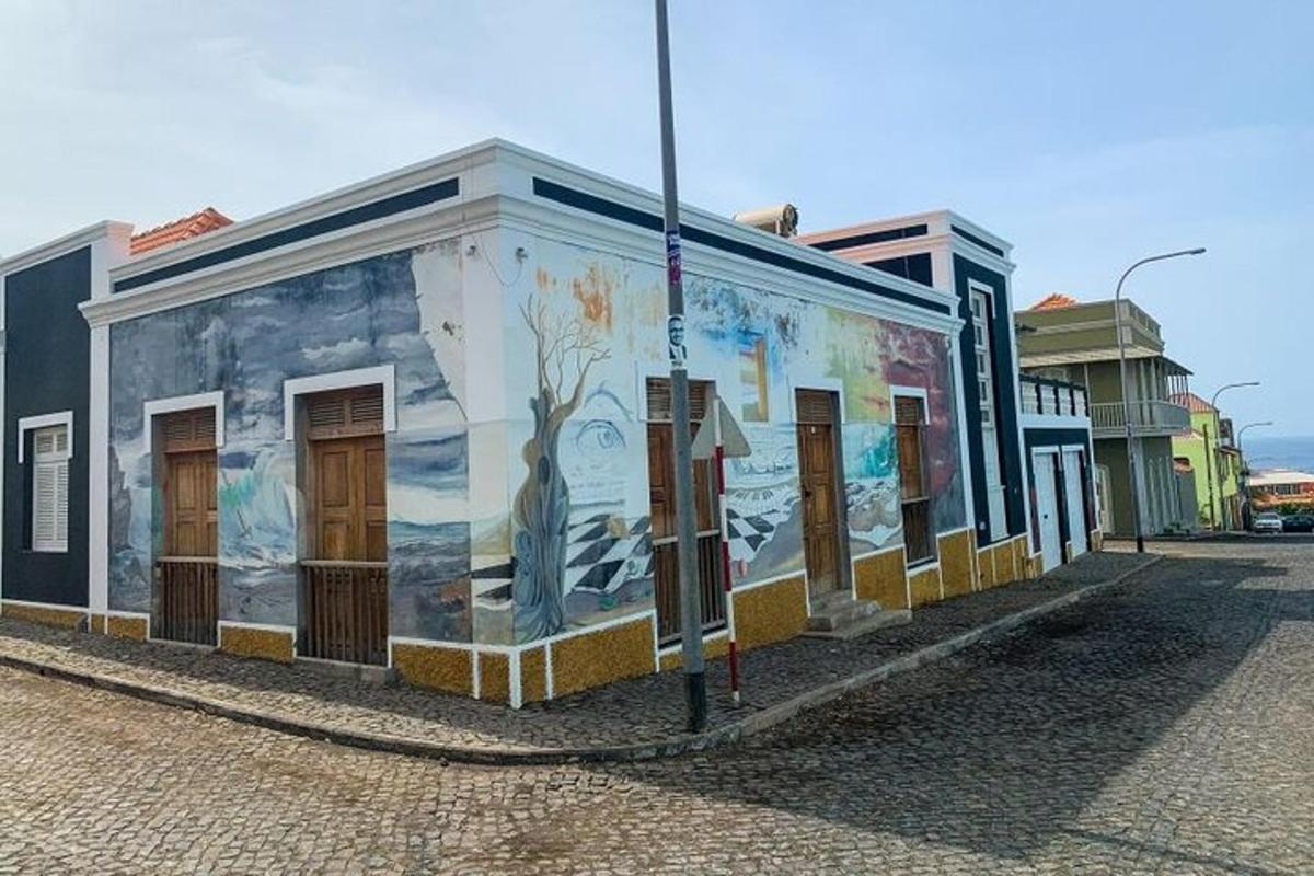a building with a mural on it on a street