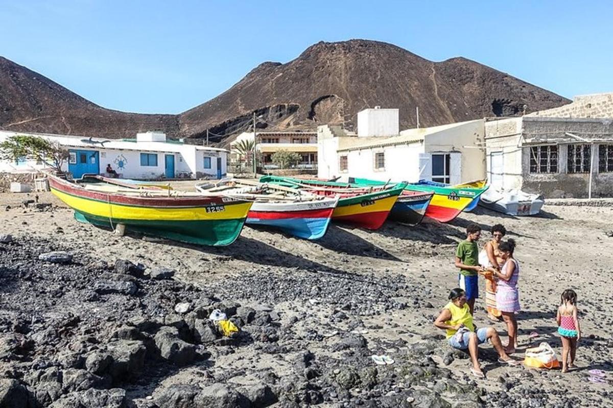 a group of people standing on a beach with boats