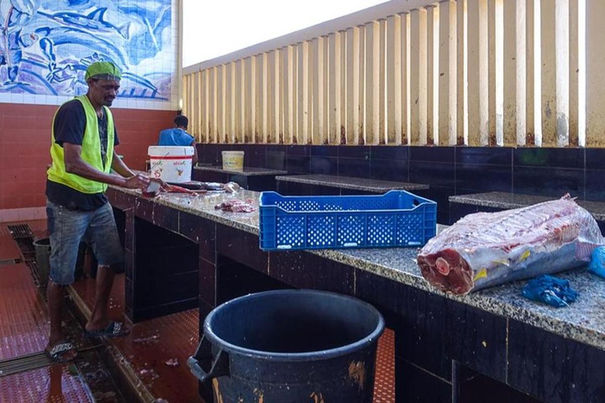 a man standing in front of a table with a container