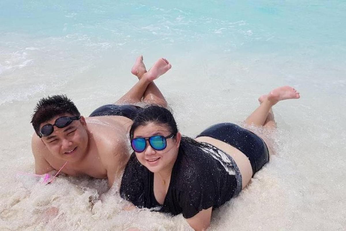 un uomo e una donna sdraiati nell'acqua della spiaggia