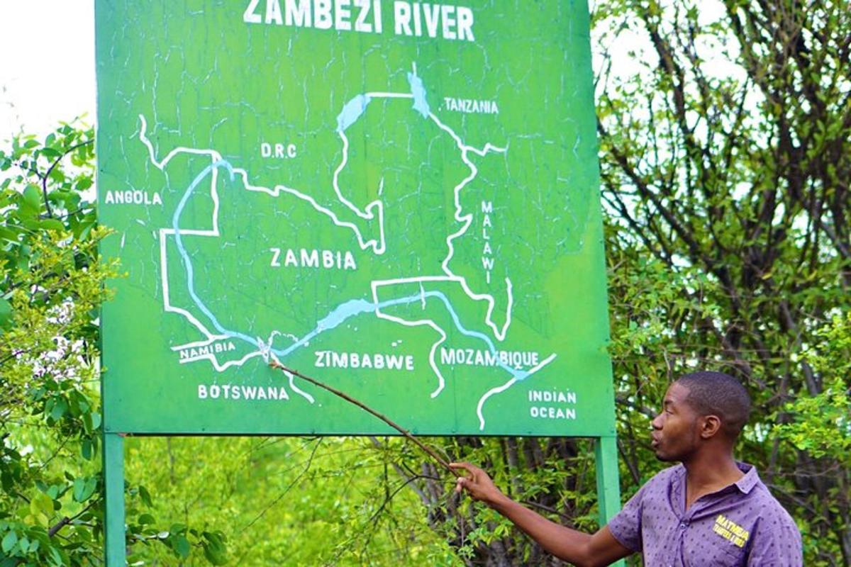 a man standing in front of a green sign