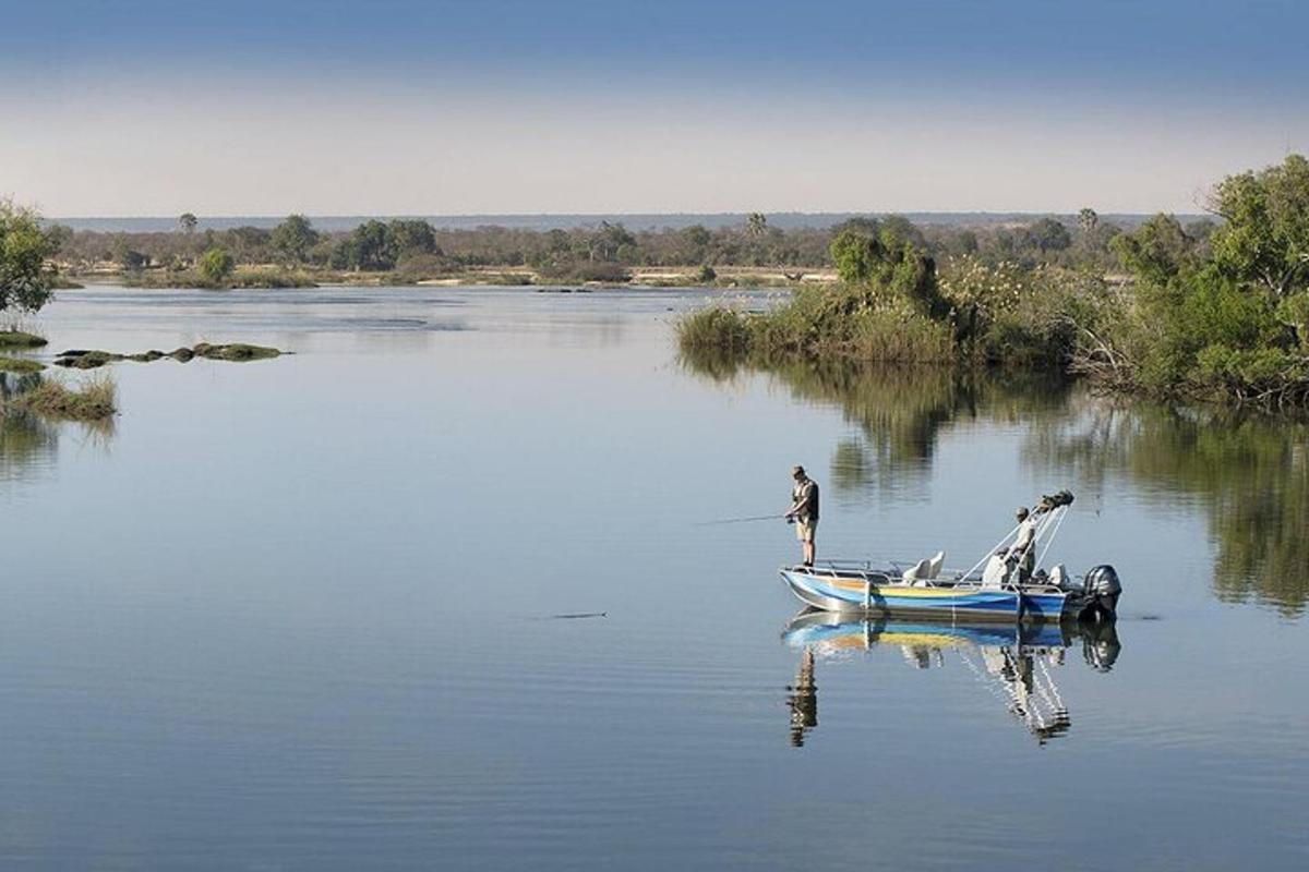 two men in a small boat on a river