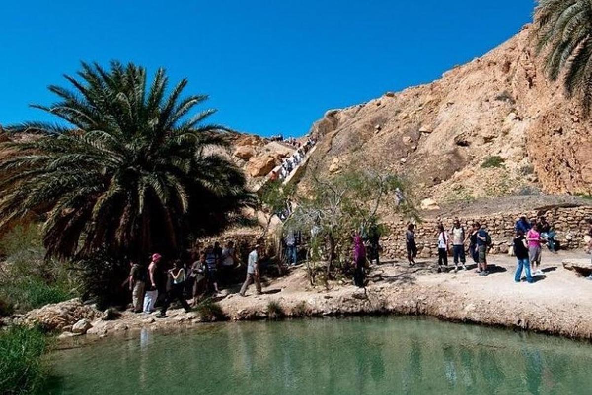 a group of people standing next to a river
