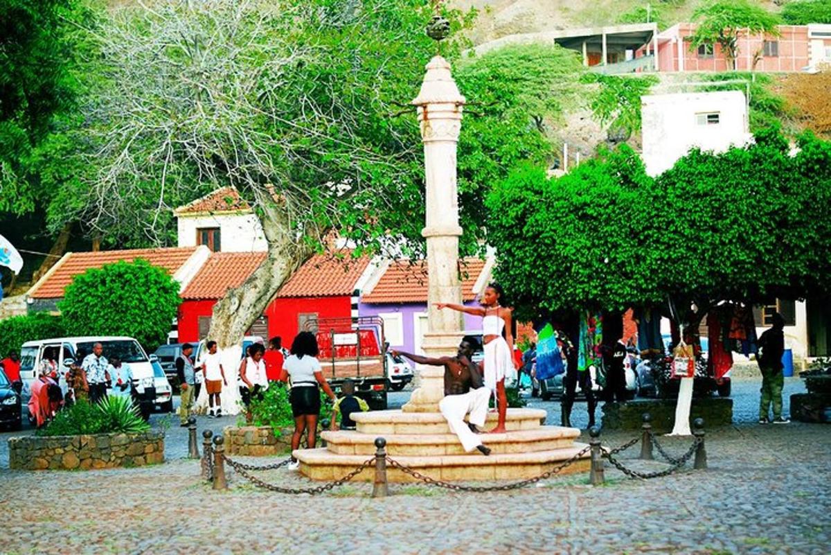 a group of people standing around a statue in a park