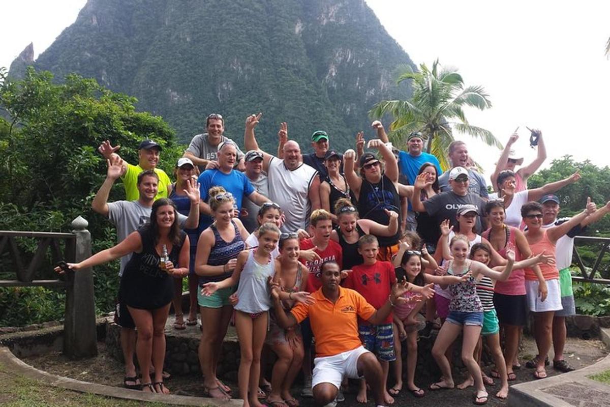 a group of people posing for a picture in front of a mountain