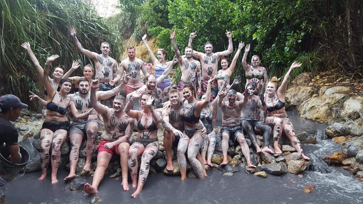 a group of men posing for a picture in a river