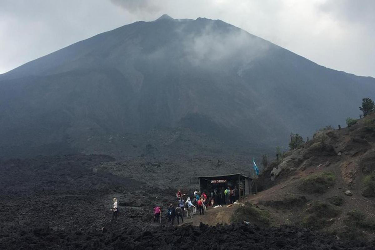 a group of people standing in front of a mountain