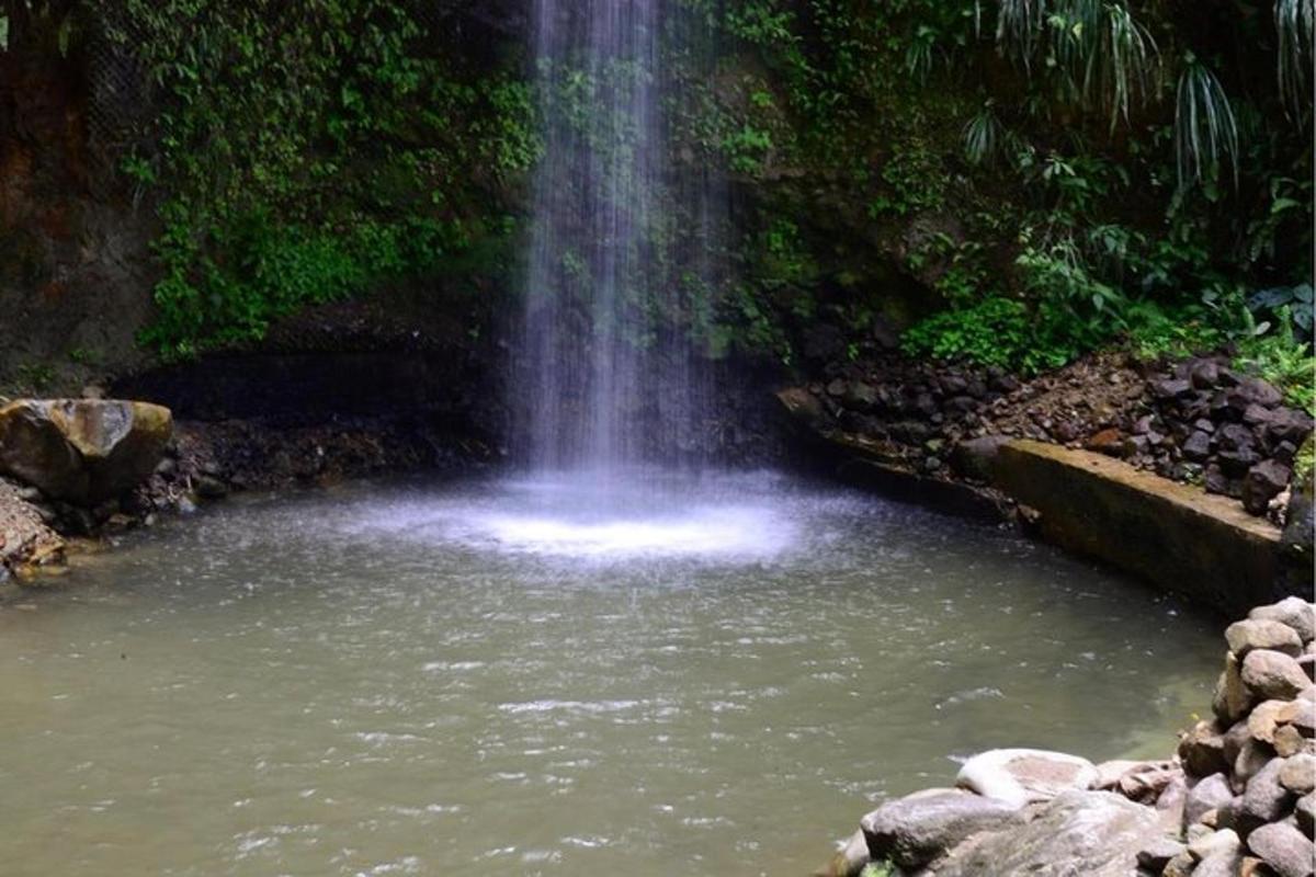 a waterfall in the middle of a pool of water
