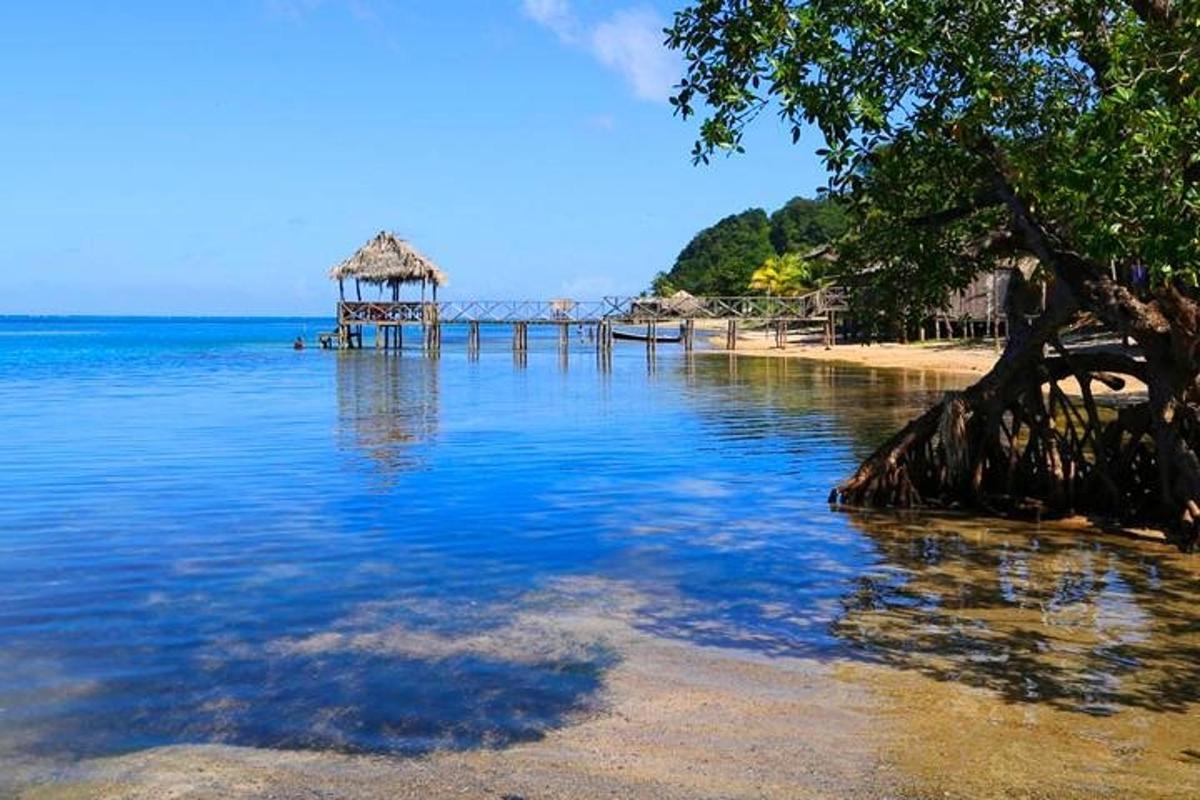 a beach with a gazebo in the middle of the water