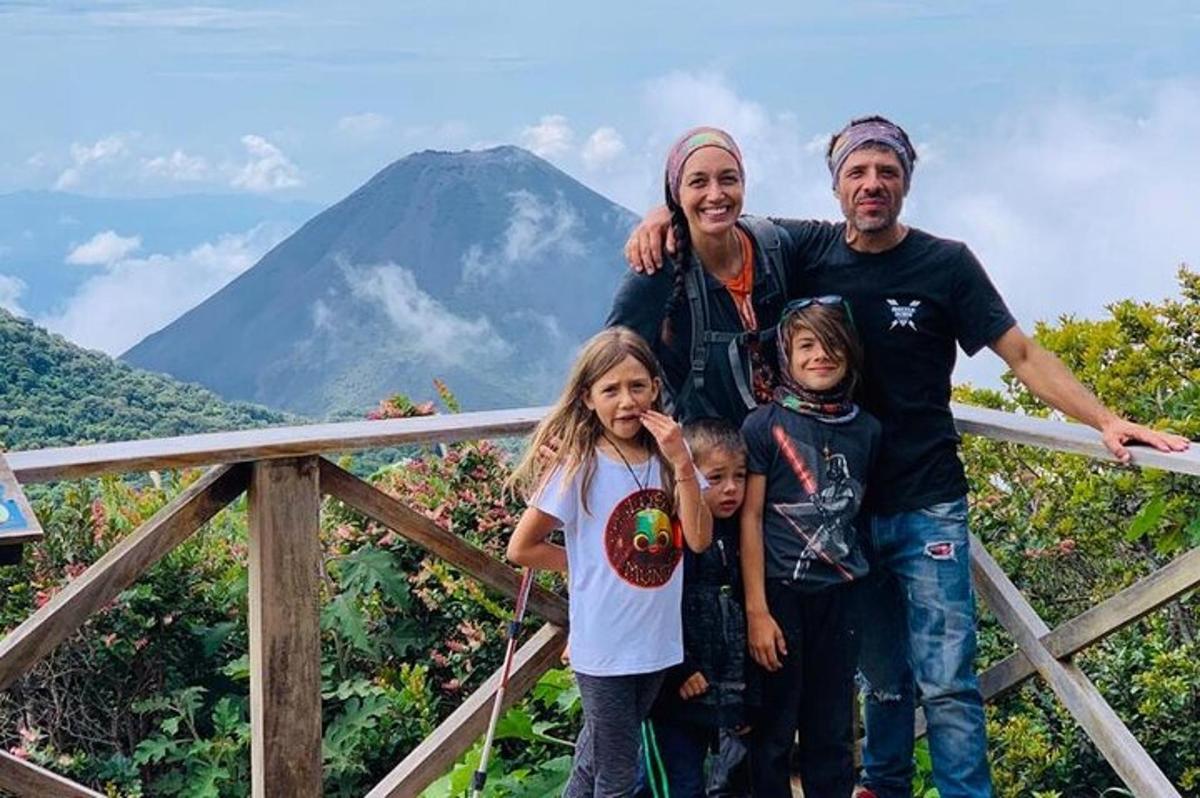 a family posing for a picture in front of a mountain