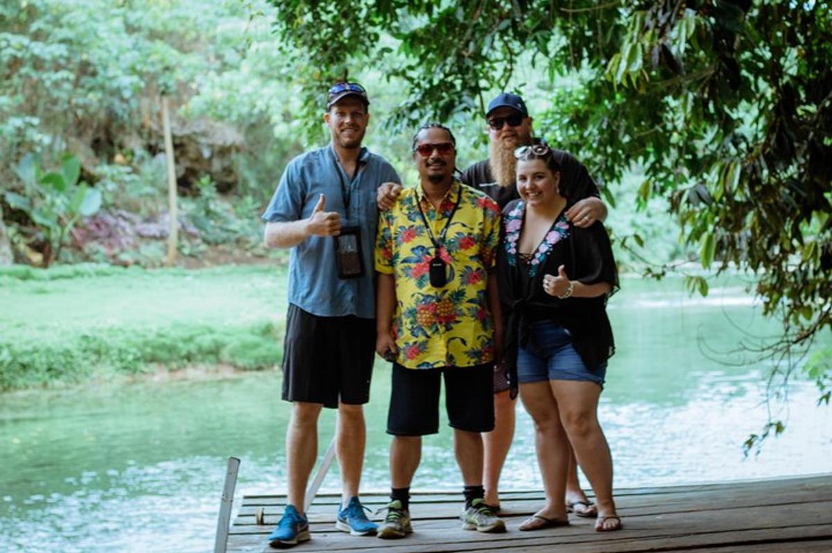 a group of people standing on a wooden bridge