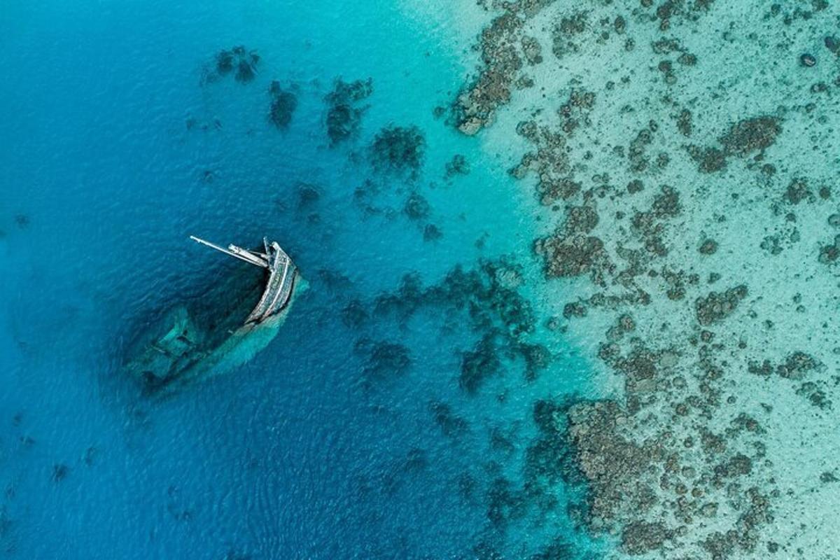 an aerial view of a boat in the ocean