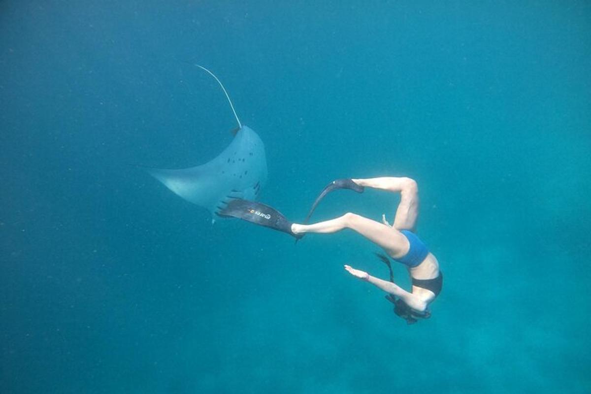 a woman in the water with an umbrella in the water