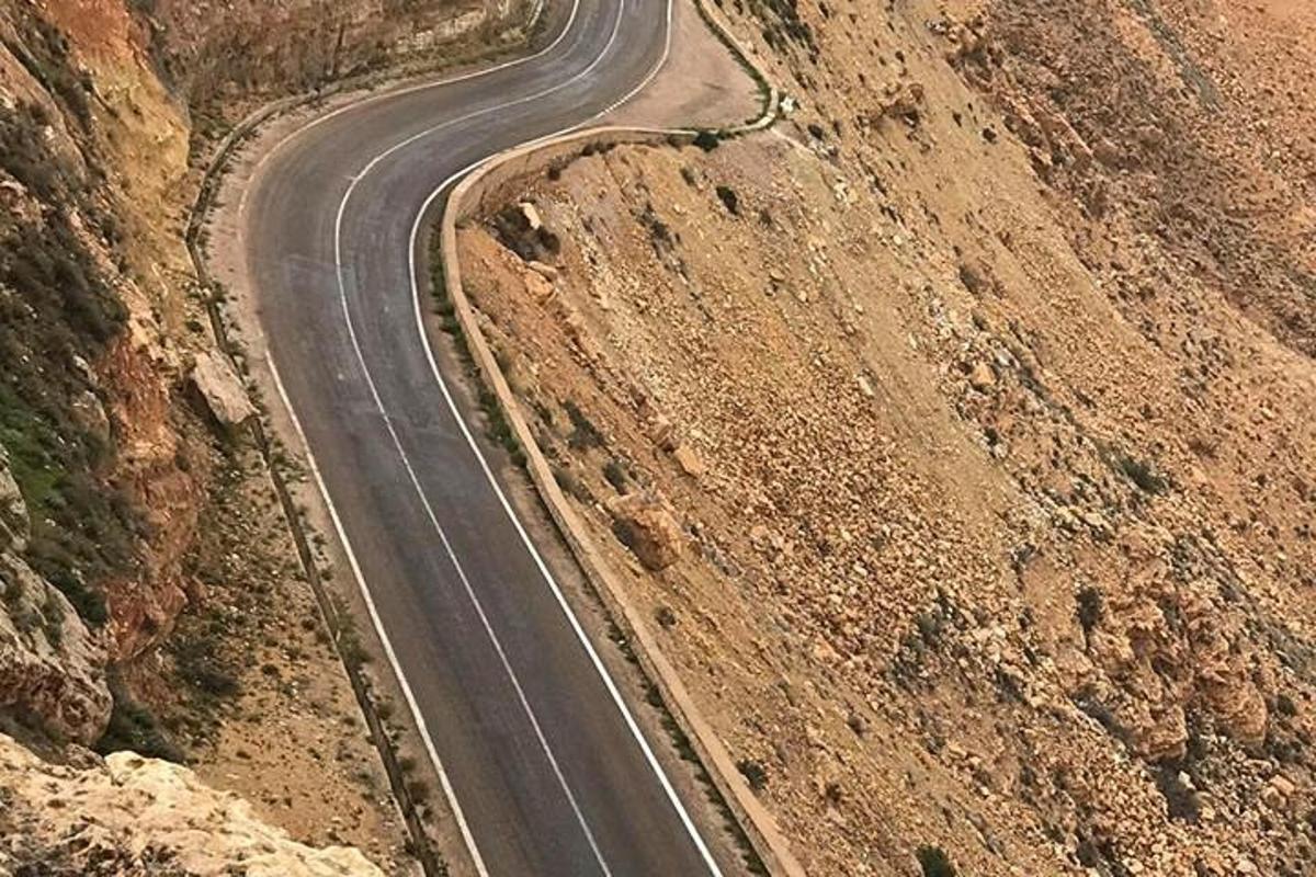 a winding road in the middle of a mountain
