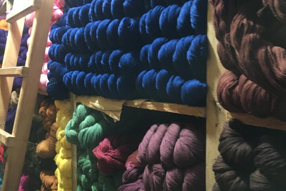 a bunch of different colored yarns on a wall