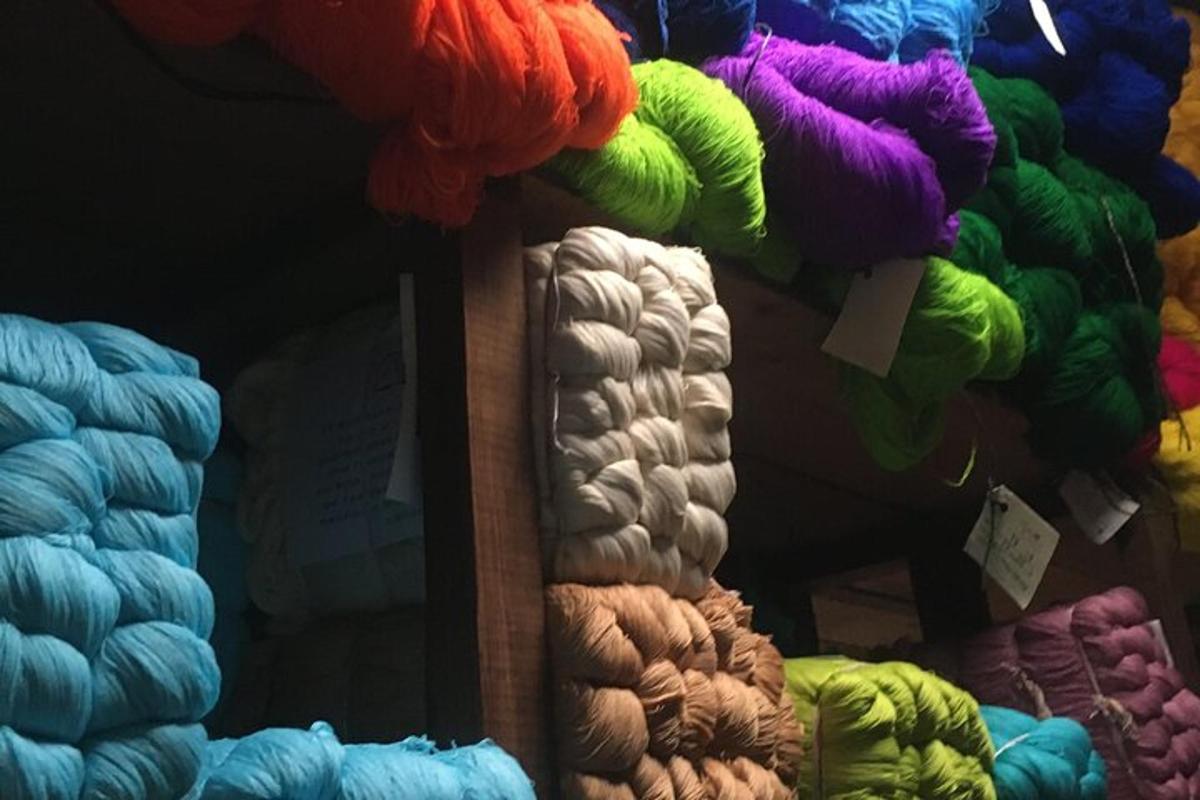 a bunch of different colored yarns on a shelf