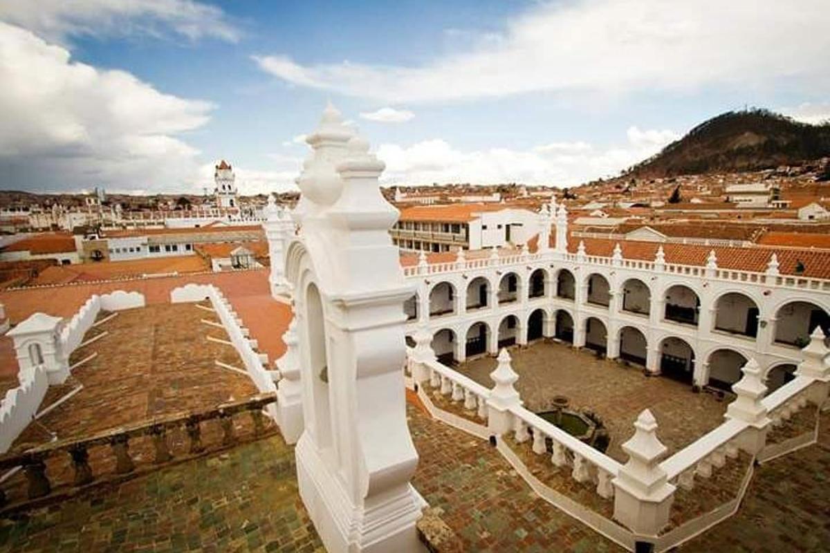 a view of a white building with a city in the background