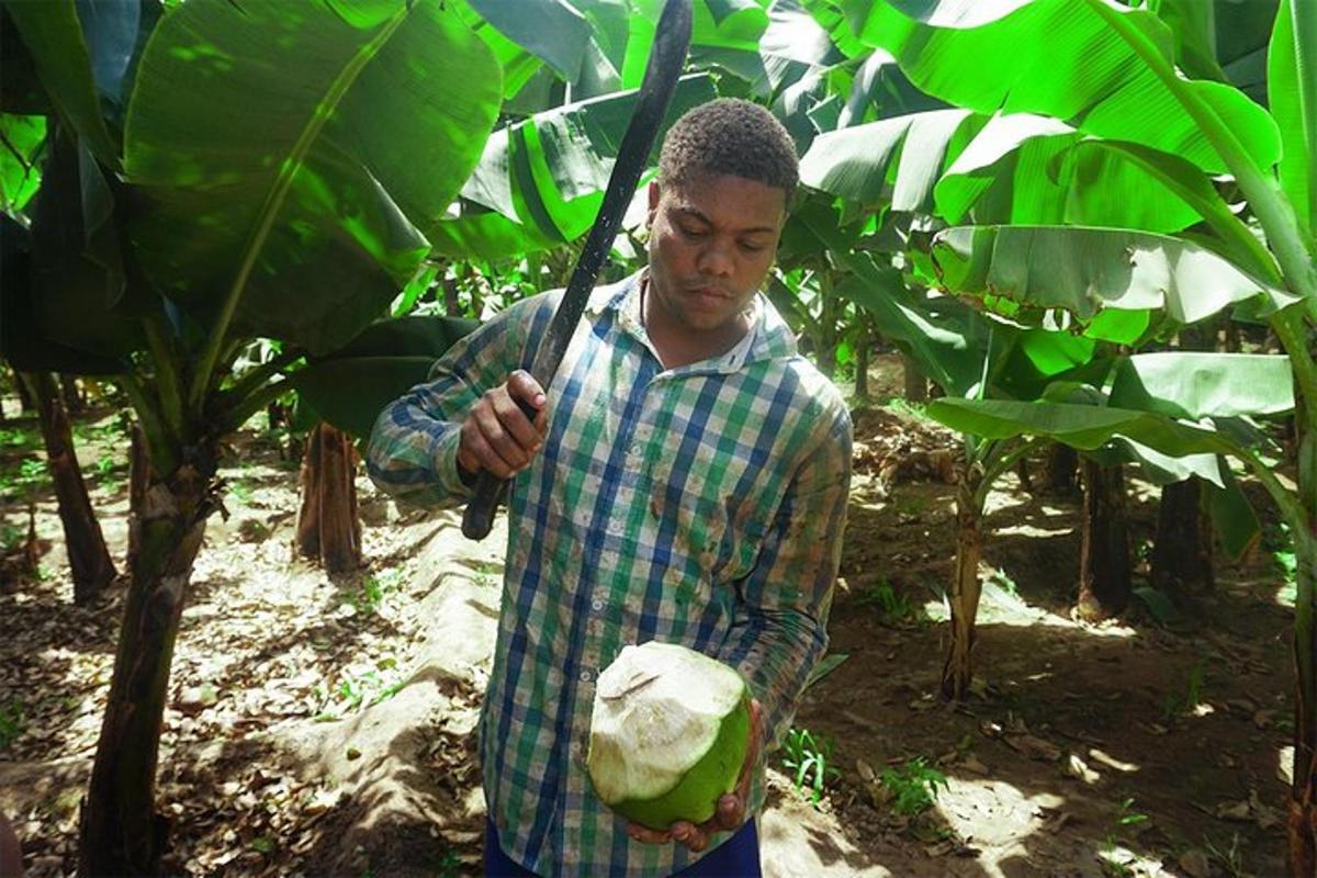 a man holding a spear and a melon