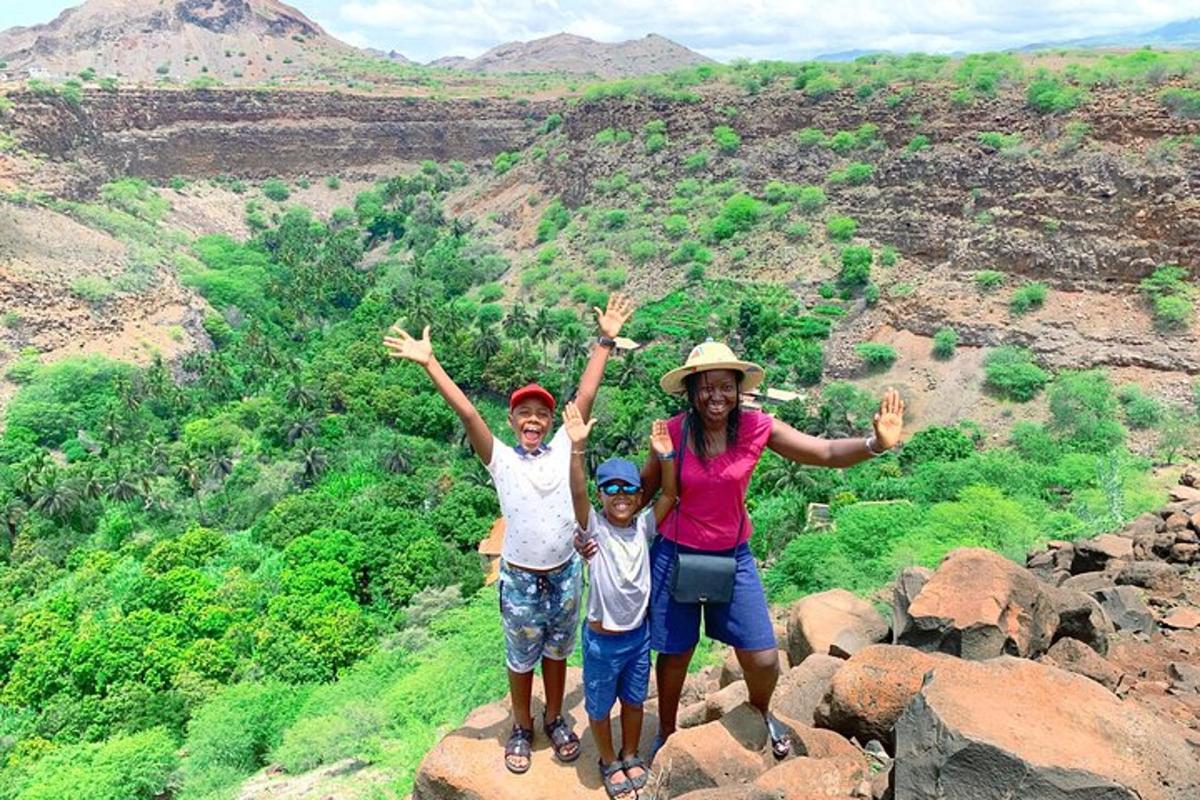 a woman and two children standing on top of a mountain