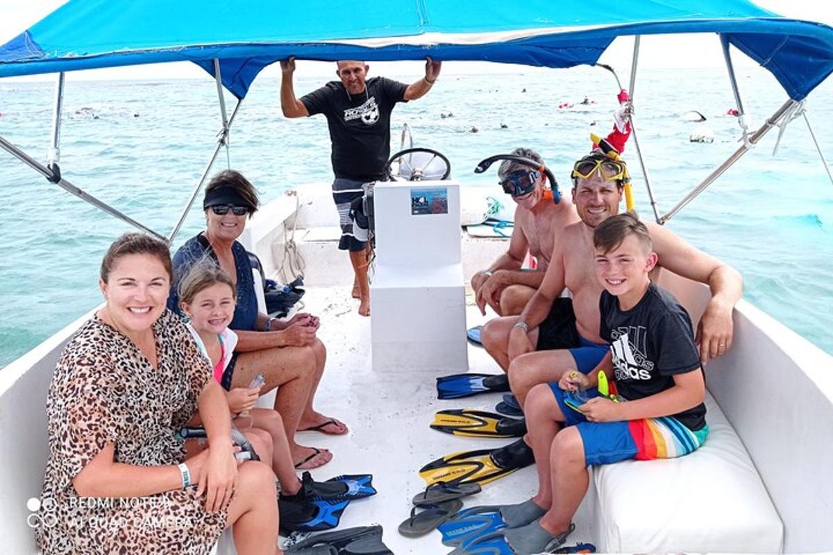 a group of people sitting on the back of a boat