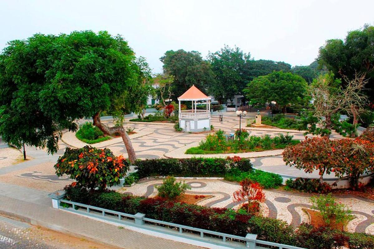 a park with a gazebo and flowers and trees