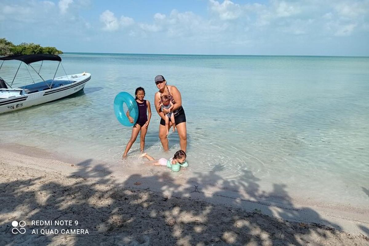 a man and two women and a child on the beach