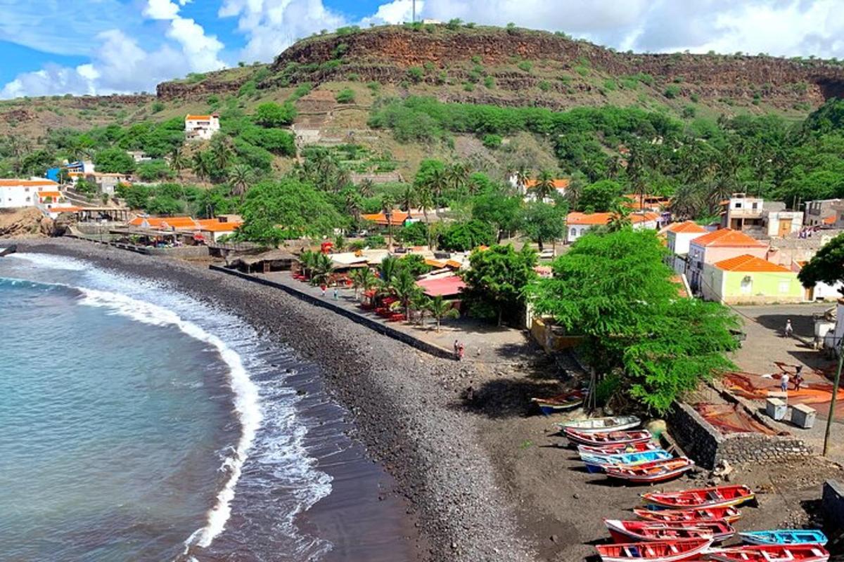 a group of boats on a beach near the water