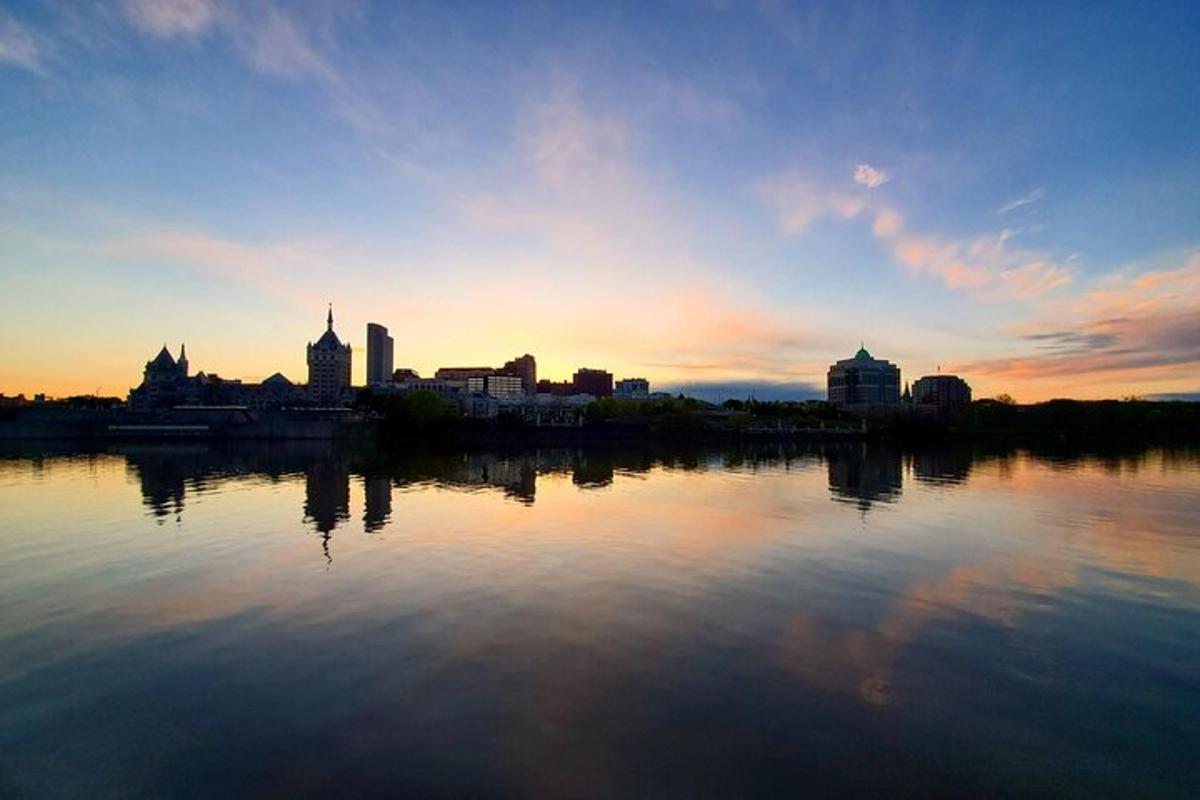 a large body of water with a city in the background