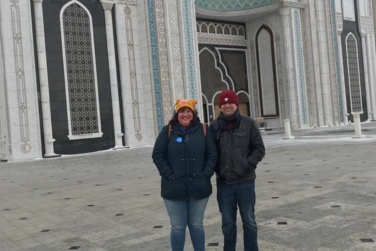a man and a woman standing in front of a building