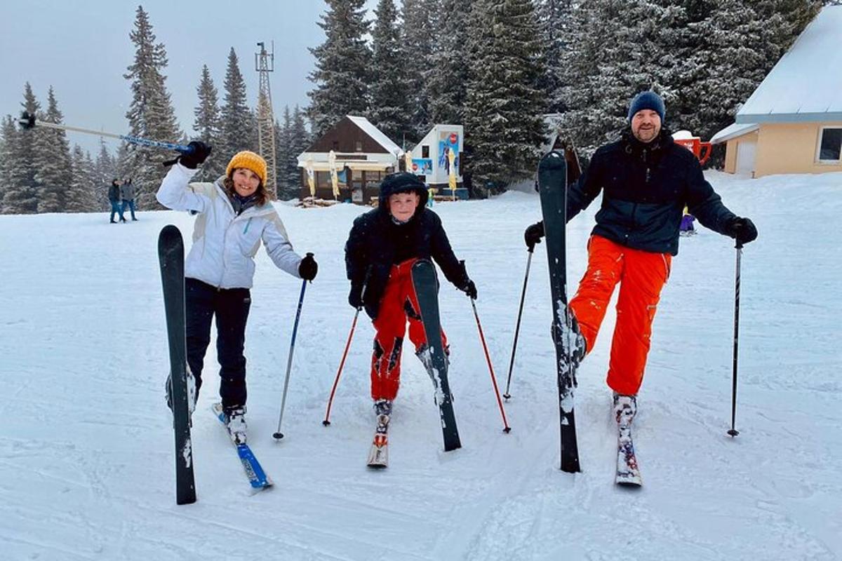 a group of three people on skis in the snow
