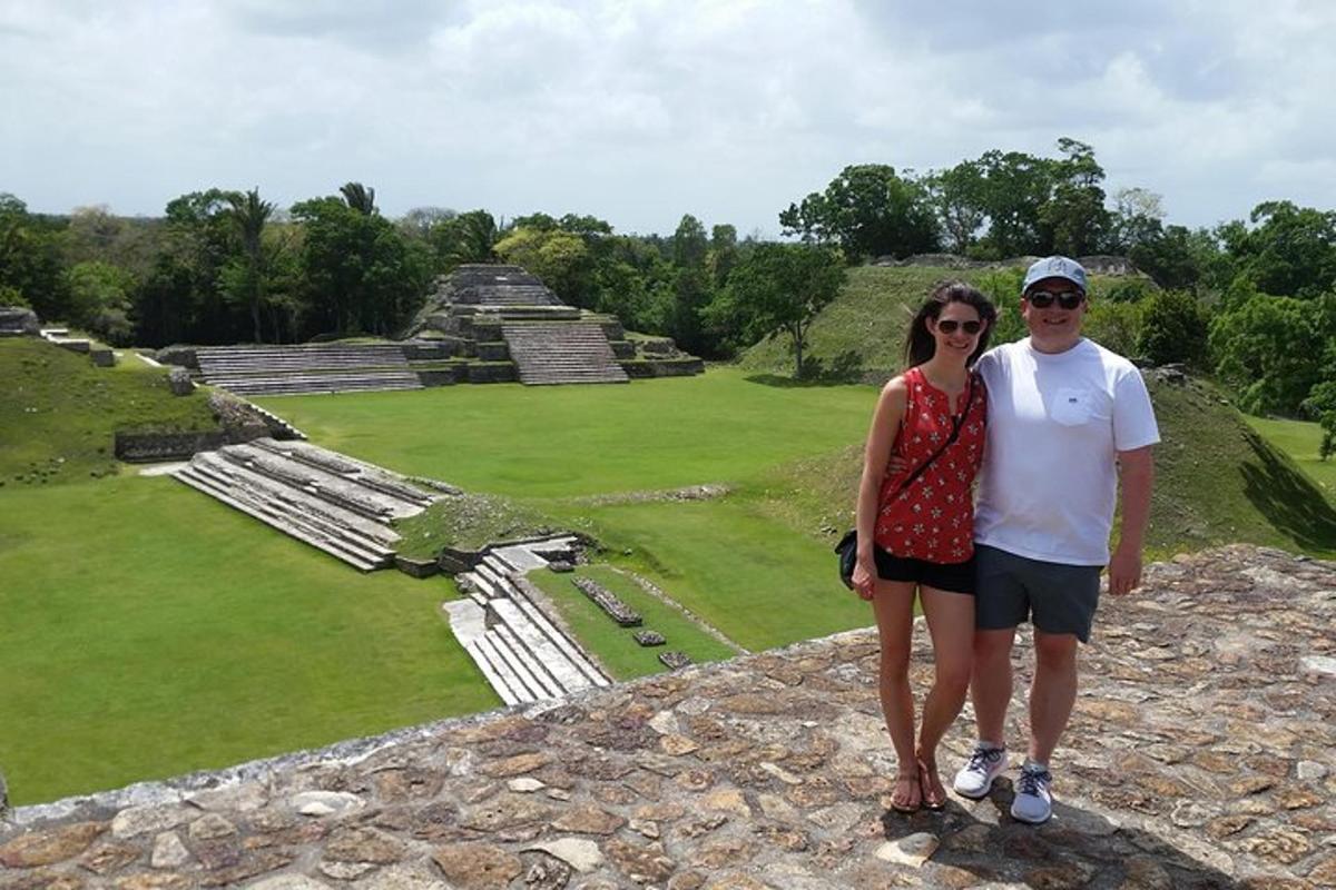 a man and a woman standing on top of a pyramid