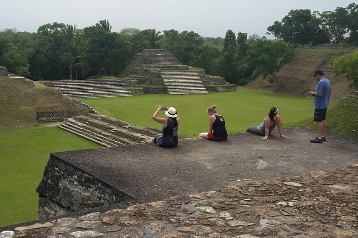 a group of people sitting on top of a pyramid