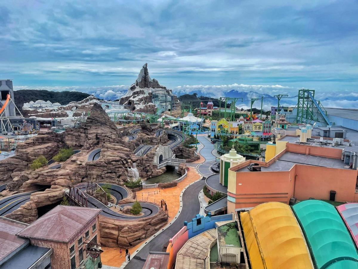 a view of a water park with a roller coaster