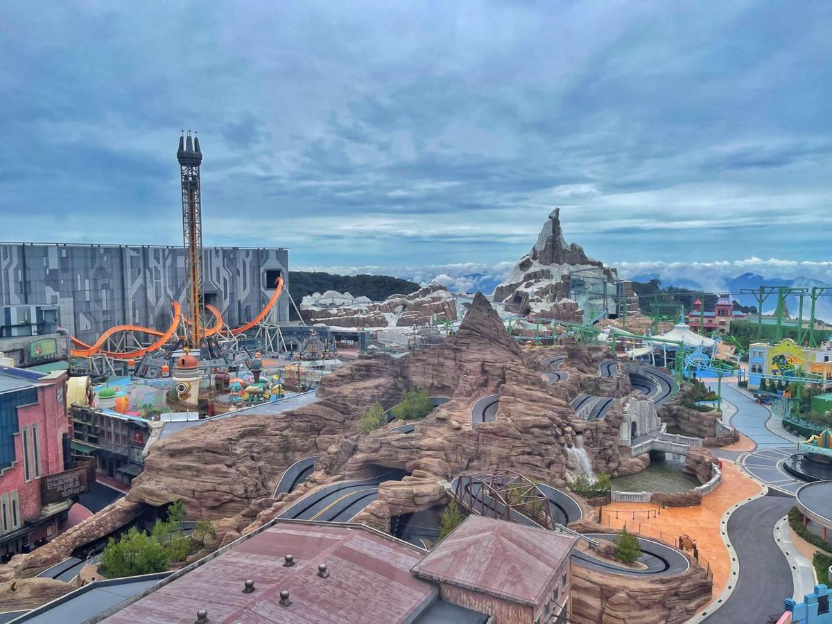 a view of a theme park with a roller coaster