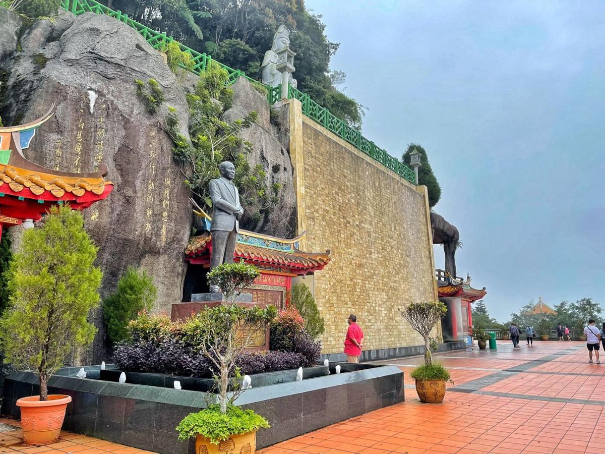 a building with a statue next to a wall