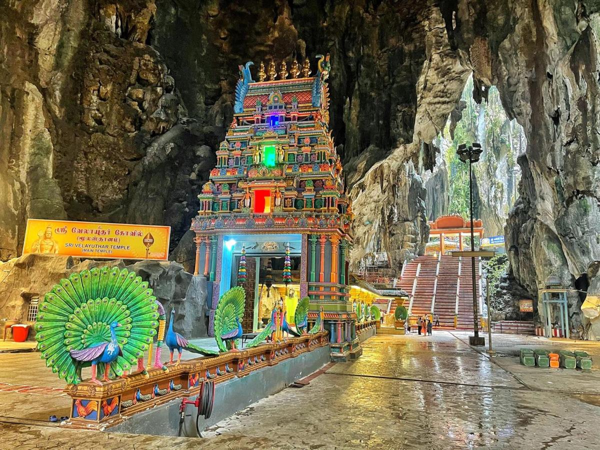 a temple in a cave with a building in front