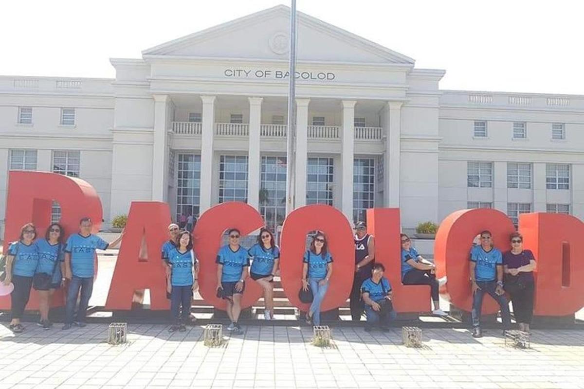 a group of people posing in front of the city of santiago