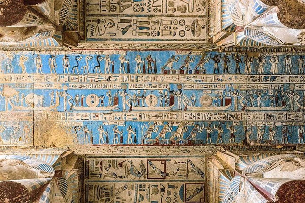 a wall with hieroglyphics on the ceiling of a building