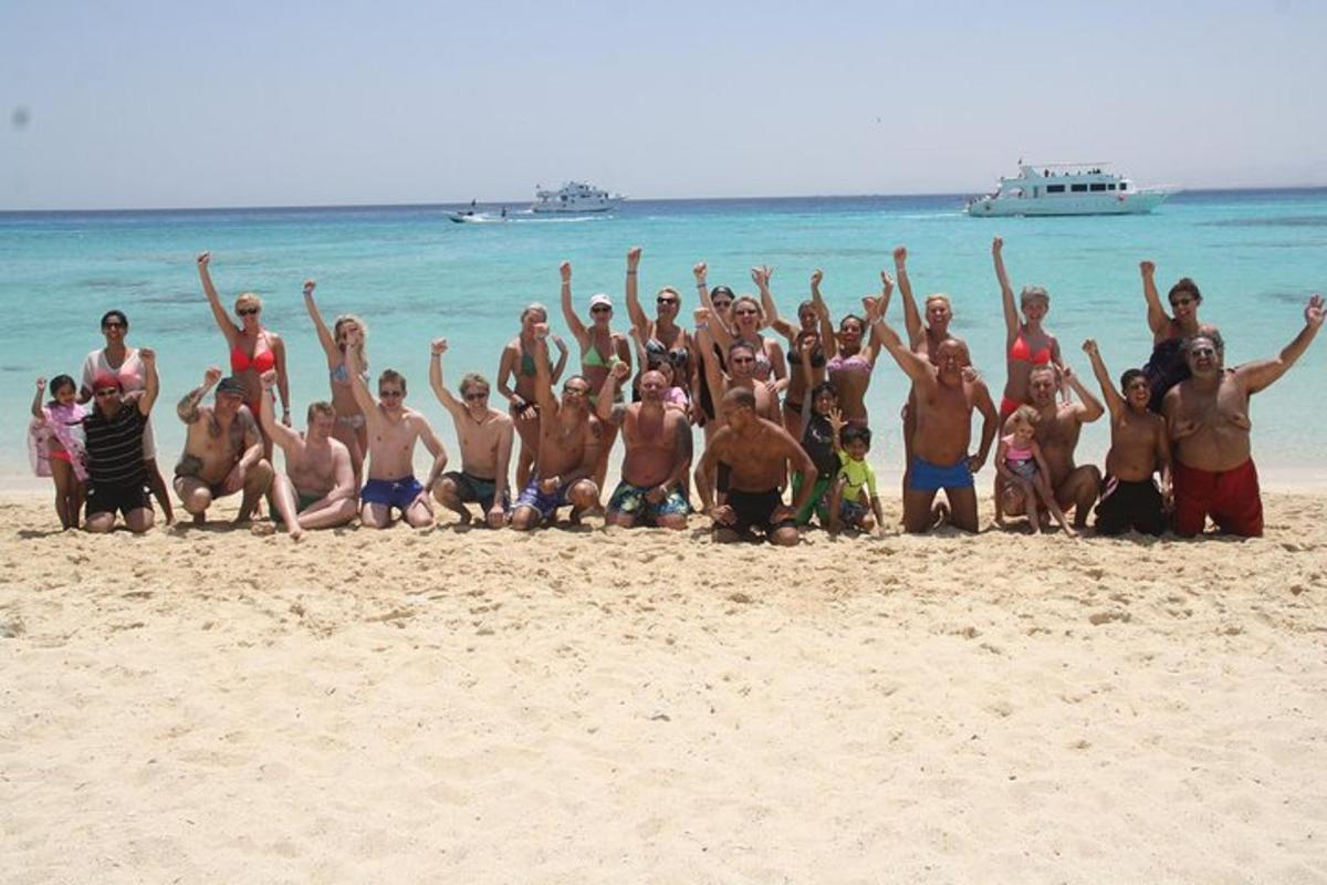 a group of people posing for a picture on the beach