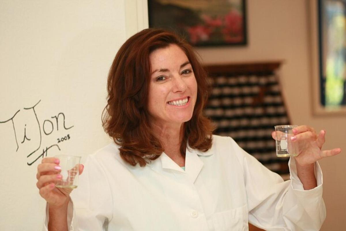 a woman holding up two glasses of wine
