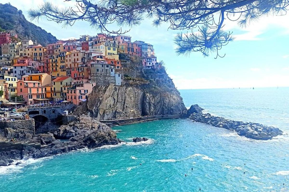a group of houses on a cliff next to the ocean